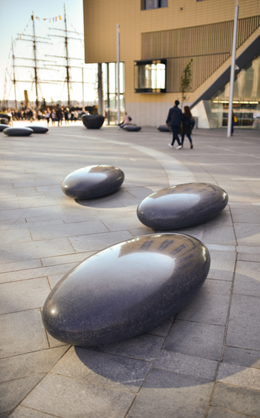 Polished Pendeen Barrell Pebble Seats cast with black concrete